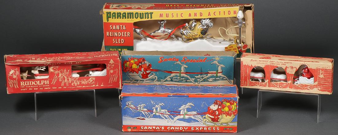 7 VINTAGE SANTAS WITH SLEIGH AND DEER: 7 VINTAGE SANTAS WITH SLEIGH AND DEER. Comprising a Paramount Music and Action Santa Reindeer Sled lamp in original box, a Bradford Rudolph sled set in original box, an Irwin Santas Reindeer Barn for 