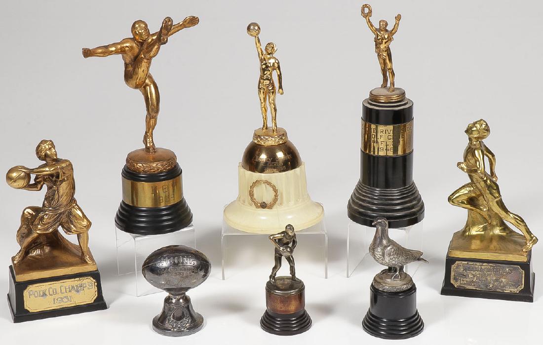 7 VINTAGE SPORTS TROPHIES, C 1930-1955: 7 VINTAGE SPORTS TROPHIES, C. 1930-1955. Comprising a '31 dated woman's basketball trophy, a 1930 two-mile relay trophy, a 1939 dated football trophy, a '55 dated girl's basket