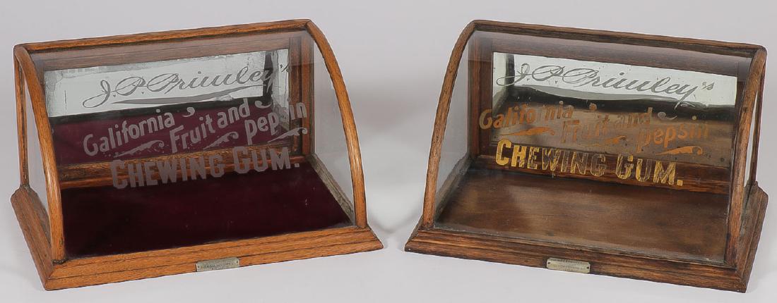 2 JP PRIMLEY'S CALIFORNIA FRUIT & PEPSIN CHEWIN: 2 J.P. PRIMLEY'S CALIFORNIA FRUIT & PEPSIN CHEWING GUM SHOWCASES. Each with curved etched glass front and drop down mirrored access door on verso with original J. Riswig maker tags. Height 9.5 inc