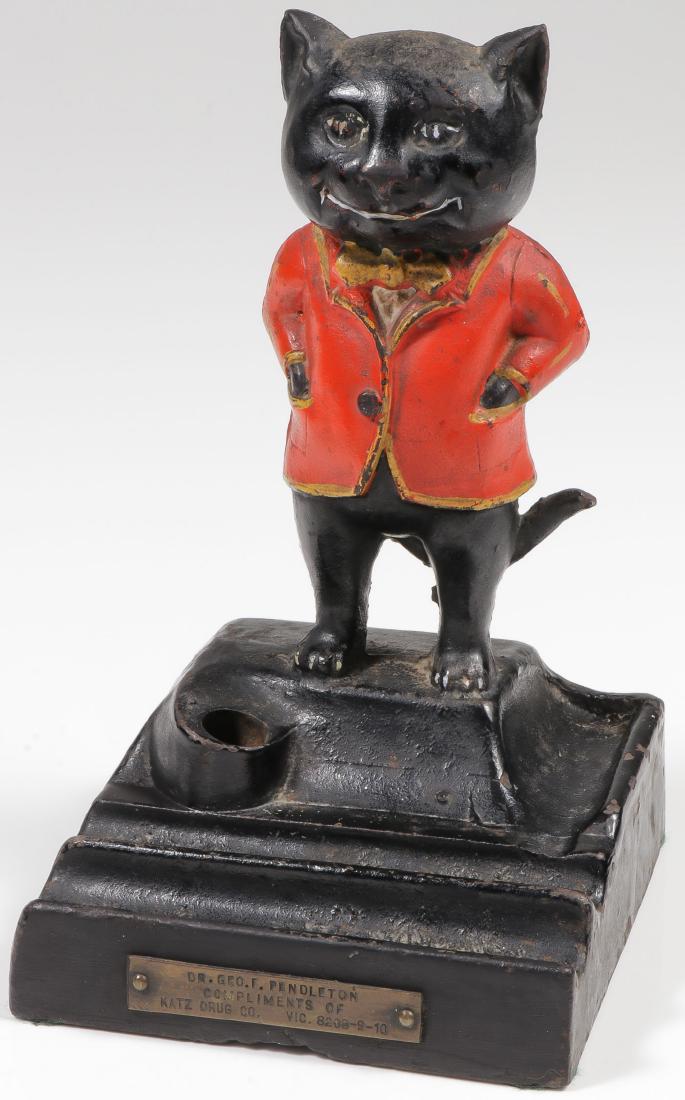 A CAST IRON KATZ DRUG PEN HOLDER: A CAST IRON KATZ DRUG PEN HOLDER. Comprising a good polychrome cast iron Katz Drug advertising desk pen holder, circa 1910 with engraved plaque to Dr. Geo F. Pendleton. Height 7.5 inches Provenance: