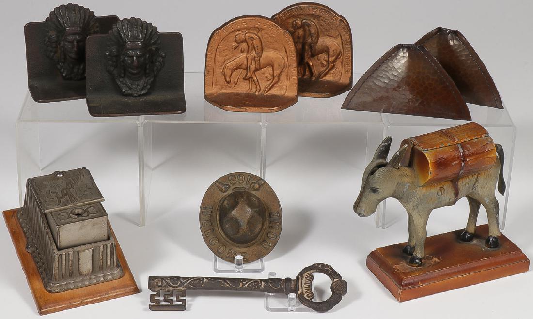 VINTAGE METAL DECORATIVE ARTS: VINTAGE METAL DECORATIVE ARTS. Comprising a good nickel-plated cigar cutter, a pair of cast iron Indian Chief bookends, a pair of cast iron "End of the Trail" Indian bookends, a pair of R