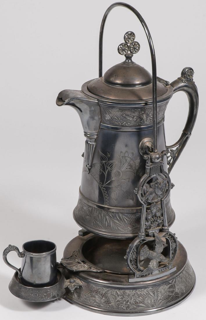 A VICTORIAN MERIDEN ORNATE PLATED ICE WATER: A VICTORIAN MERIDEN ORNATE PLATED ICE WATER. Ornately decorated with hummingbird framework and raised reliefs, and with a non-matching quadruple plated cup. Overall height 19.5 inches.