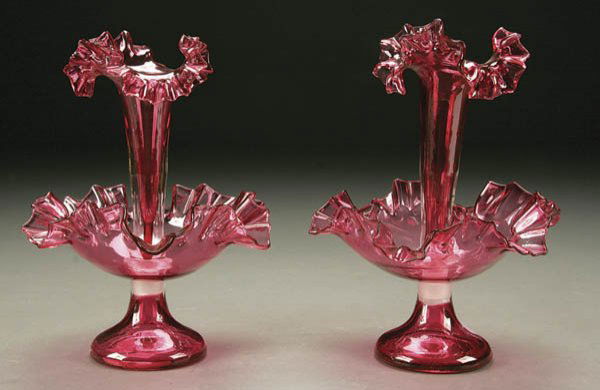 A PAIR OF CRANBERRY GLASS EPERGNES; 20th century;: A PAIR OF CRANBERRY GLASS EPERGNES; 20th century; footed compote form with central ruffled rim trumpet. Height 9 inches. Estimate $100-$200