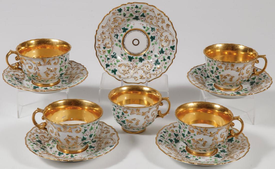 IMPERIAL RUSSIAN PORCELAIN CUPS & SAUCERS, NI: A SET OF FIVE RUSSIAN IMPERIAL PORCELAIN MANUFACTORY CUPS AND SAUCERS, PERIOD OF NICHOLAS I. Comprising five matching cups and saucers both with matching ornate raised designs of scrolling vines and w