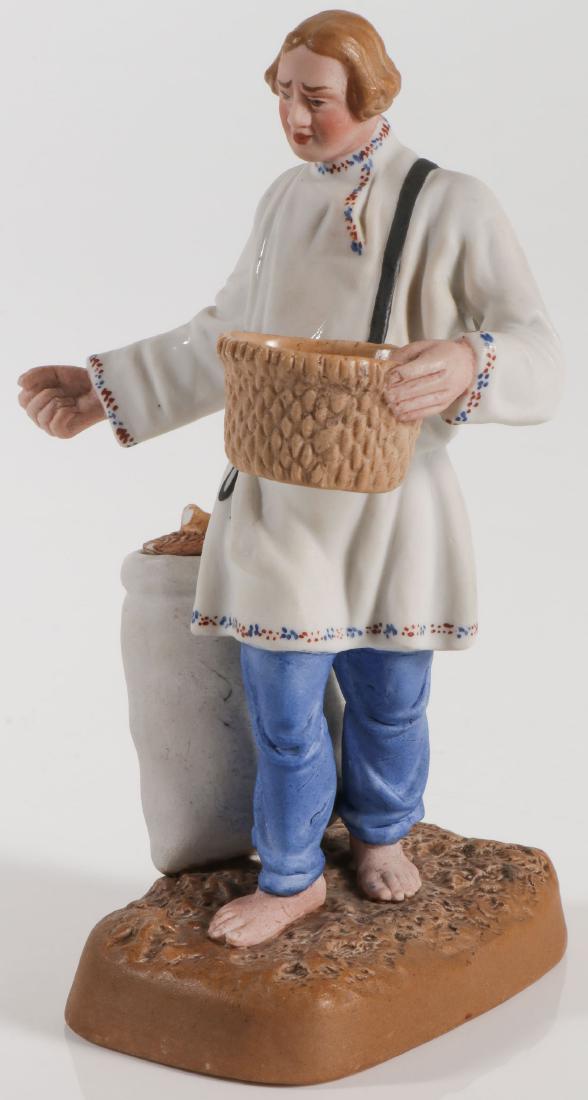 SCARCE RUSSIAN PORCELAIN FIGURE OF A SOWER: SCARCE RUSSIAN PORCELAIN FIGURE OF A SOWER, C. 1920'S. Realistically modelled in traditional costume holding a basket and sowing seed. The base with seed sack with fitted cover. Underside of base with