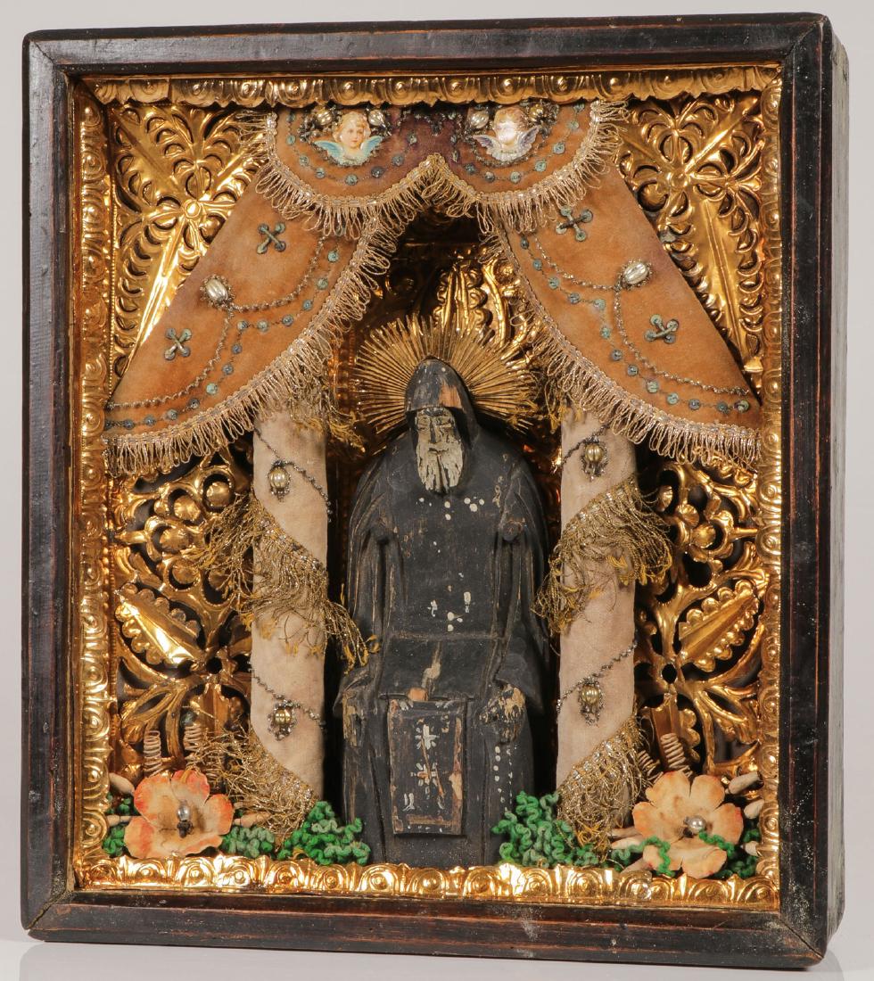 INTERESTING RUSSIAN ICON ST NIL STOLBENSKY 19TH C: AN INTERESTING RUSSIAN ICON OF ST. NIL STOLBENSKY, 19TH CENTURY. Set within an ornately decorated shadow box frame (kiot) is a carved and polychromed wood figure of the sixteenth century monastic sain