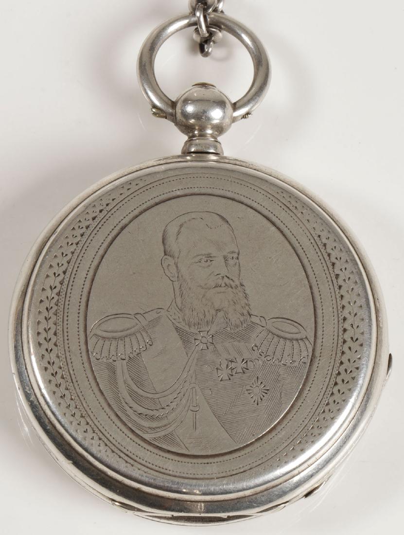 TSAR ALEXANDER III ENGRAVED POCKET WATCH, C 1885: A SWISS FOR THE RUSSIAN MARKET KEY WIND POCKET WATCH, CIRCA 1885. The silver hunt case engraved with bust portrait of Tsar Alexander III in uniform. The verso with engraved cartouche of battle trophi
