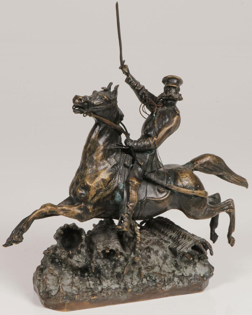 BRONZE OF CHARGING SOLDIER ON HORSEBACK: A RUSSIAN STYLE BRONZE OF A CHARGING SOLDIER ON HORSEBACK, PROBABLY 2ND HALF 20TH C. Sculpted in full round of good proportions and anatomy, depicting a cavalry officer with sword drawn and bounding o