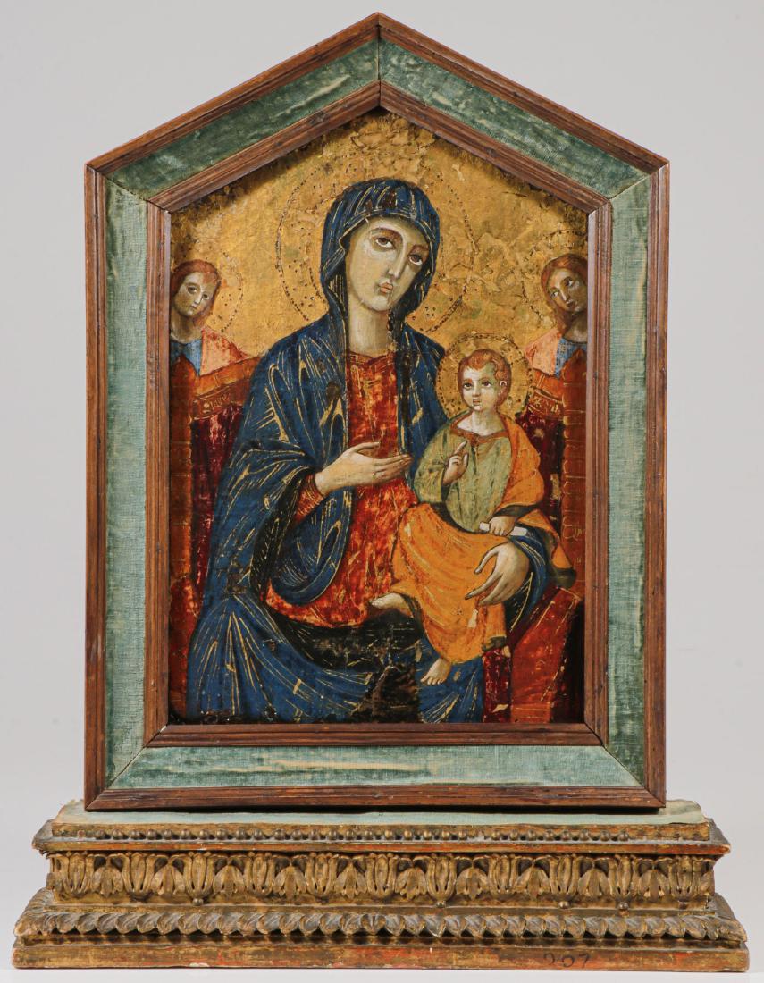 SIENESE STYLE PAINTING OF THE MADONNA AND CHILD: A SIENESE STYLE PAINTING OF THE MADONNA AND CHILD. Executed on a shaped wood panel, depicting an enthroned virgin holding the infant Christ who holds a scroll with one hand and delivers a blessing wit