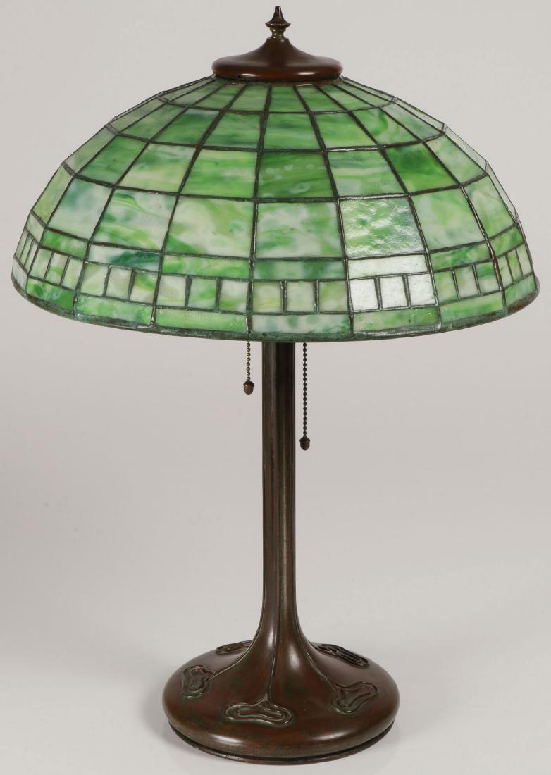TIFFANY "GEOMETRIC" SHADE & ASSOCIATED BASE: TIFFANY STUDIOS "GEOMETRIC" LEADED GLASS SHADE & ASSOCIATED BASE. Comprising a domed leaded glass shade with favrile opaque to semi-opaque mottled green glass panels (No. 1901) on an associated bronze