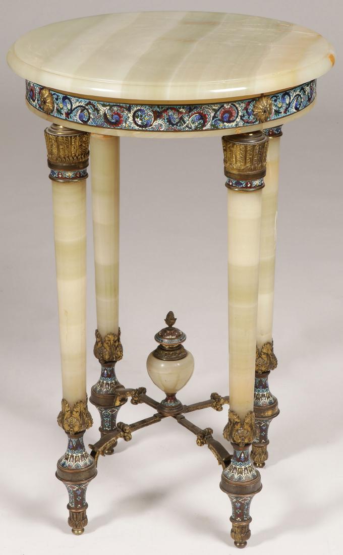 A FRENCH ONYX GILT BRONZE AND ENAMEL TABLE C 1900: A FRENCH ONYX GILT BRONZE AND ENAMEL TABLE, CIRCA 1900. In the Louis the XVI style, the round onyx surface with beveled rim resting on a Gueridon table base, the skirt banded in champlevÉ enamel 