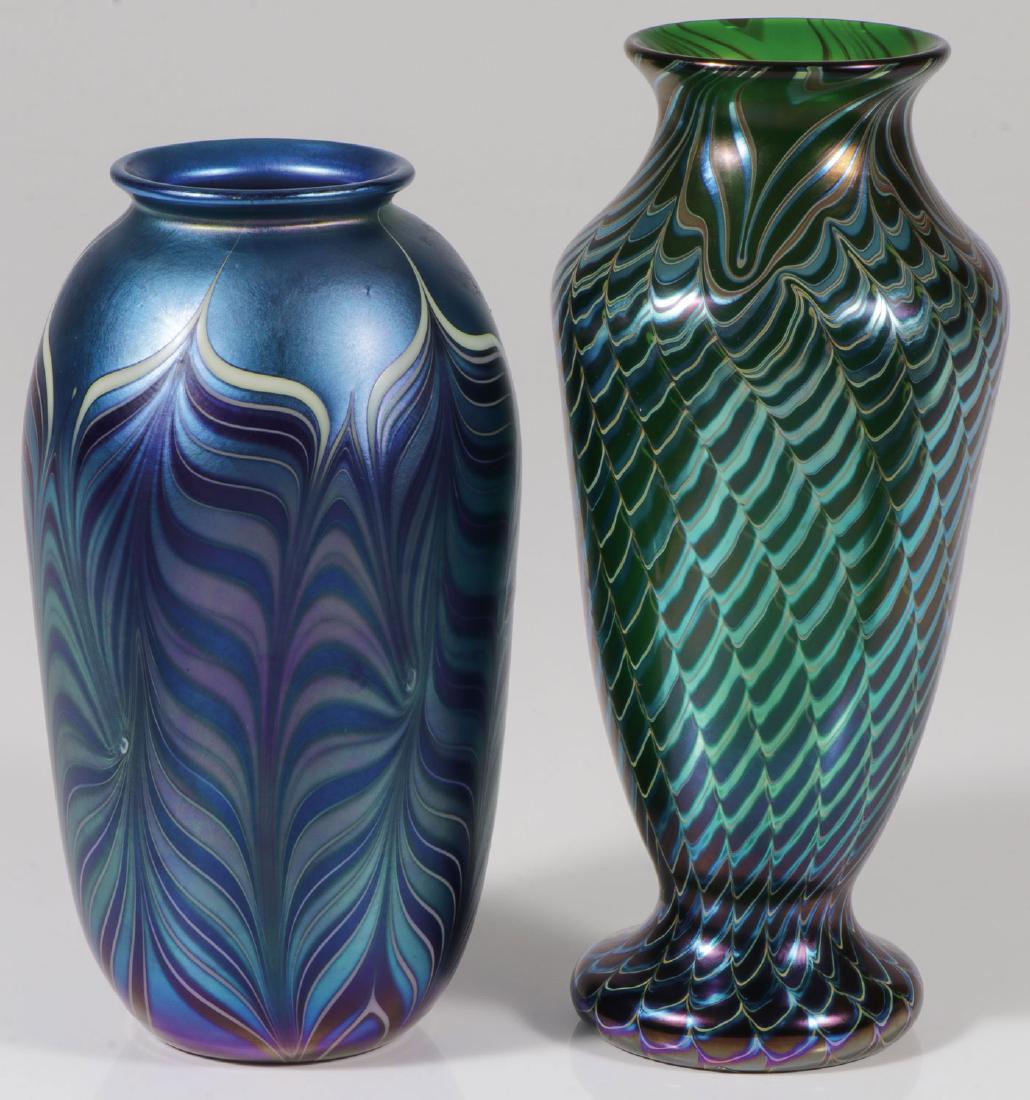 A PAIR OF ORIENT AND FLUME ART GLASS VASES: A PAIR OF ORIENT AND FLUME ART GLASS VASES. Comprising an iridized vase with flared foot and rim and overall decorated with a lace pattern. Signed on base O + F and dated 1979. Height 9.6 inches. Toge