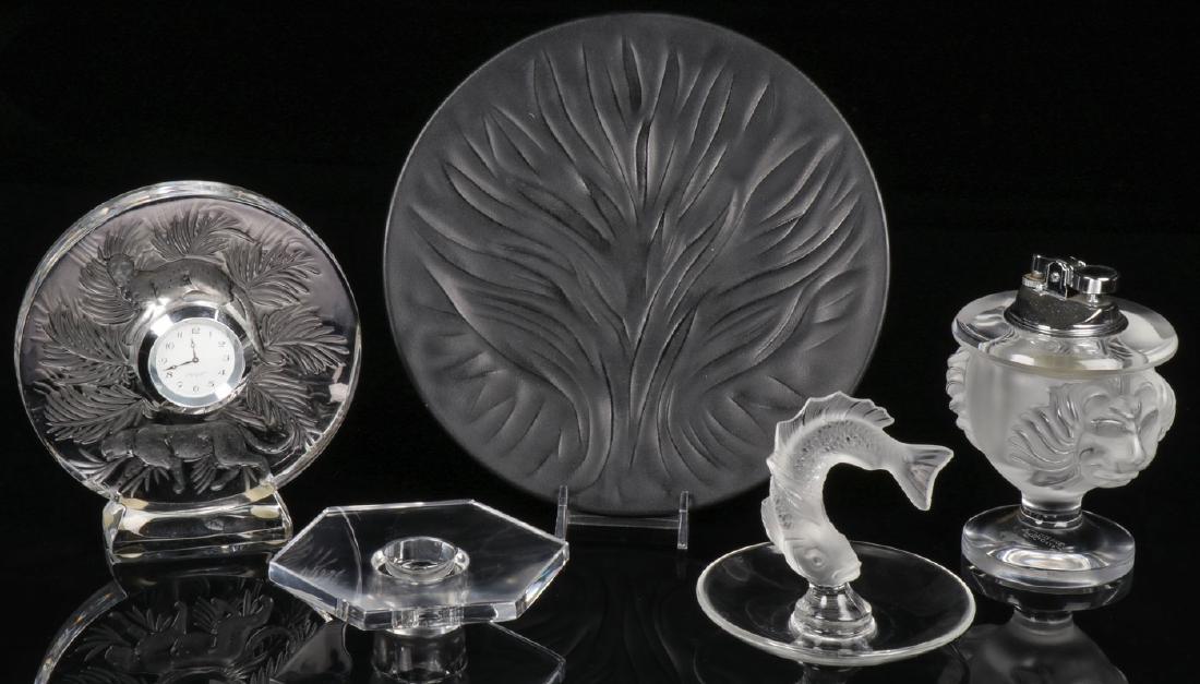 FOUR PIECES OF LALIQUE: FOUR PIECES OF LALIQUE. Comprising a Pendulette Jungle clock, height 5.4 inches (13.8 cm), an Algues plate in black frosted finish, diameter 7.9 inches (20 cm), a Goujon ring tray, and a Tete De lion 