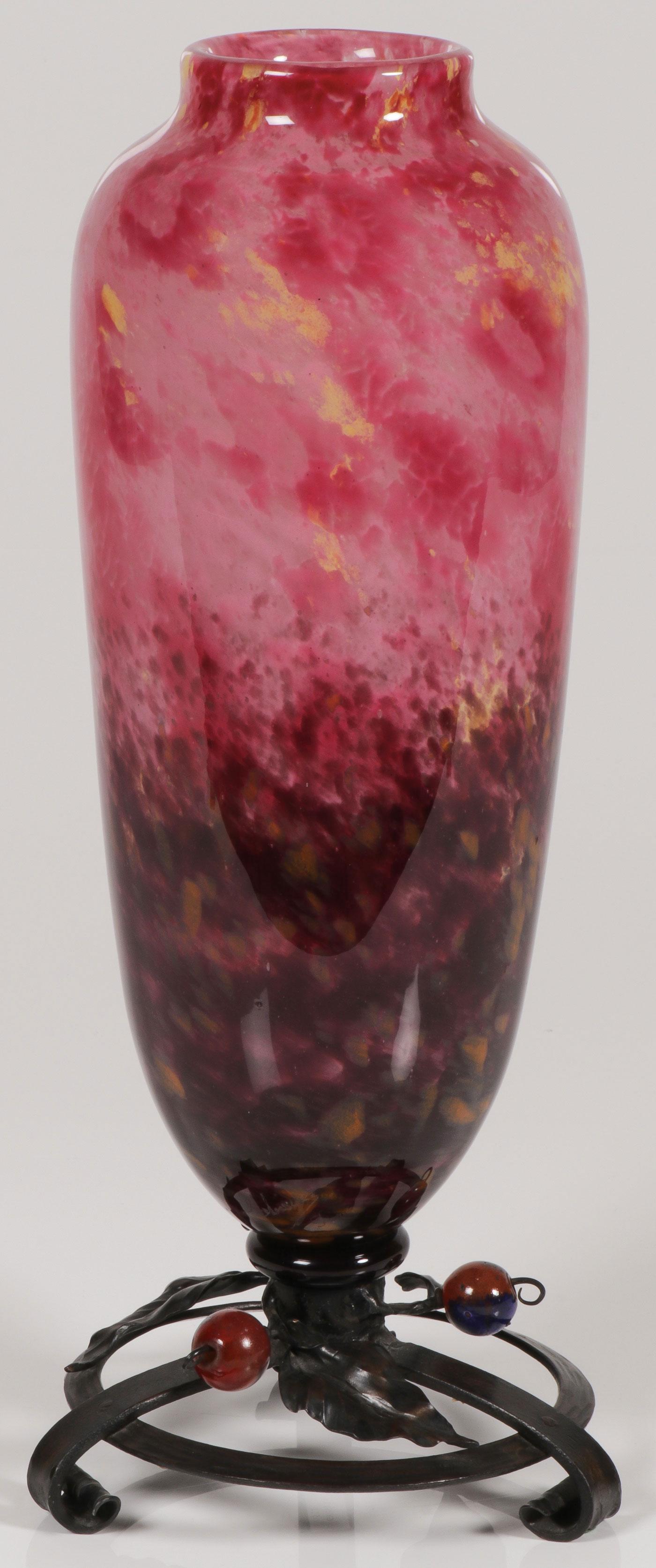 A SCHNEIDER ART GLASS VASE, CIRCA 1930: A SCHNEIDER ART GLASS VASE, CIRCA 1930. The elongated amphora style vase with tapering sides in mottled multi-colored decoration resting on the original integral wrought iron base with glass cherries 