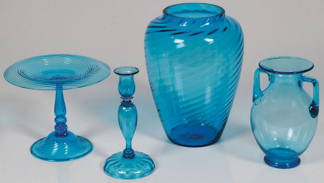 GROUP OF STEUBEN ART GLASS: GROUP OF STEUBEN ART GLASS. Comprising a group of four Steuben blue glass objects including a large swirl form vase marked on underside Steuben, height 11 inches, a double handled amphora style vase, 