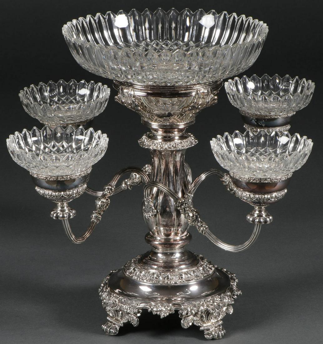 ORNATE CUT GLASS & SILVER-PLATED EPERGNE, 19TH C: AN ORNATE CUT GLASS & SILVER-PLATED EPERGNE, 19TH C. Comprising a large and impressive weighted silver-plated center piece epergne resting on four scroll feet with baluster central pedestal set with f