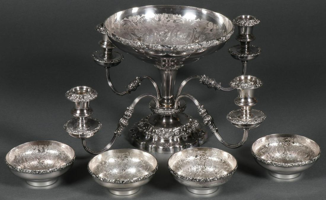 AN ENGLISH SILVER PLATED EPERGNE: AN ENGLISH SILVER PLATED EPERGNE. Comprising a large and impressive silver plated epergne by Ellis. The ornate shaped base beneath a central node mounted with four scroll arms set with candle sockets 