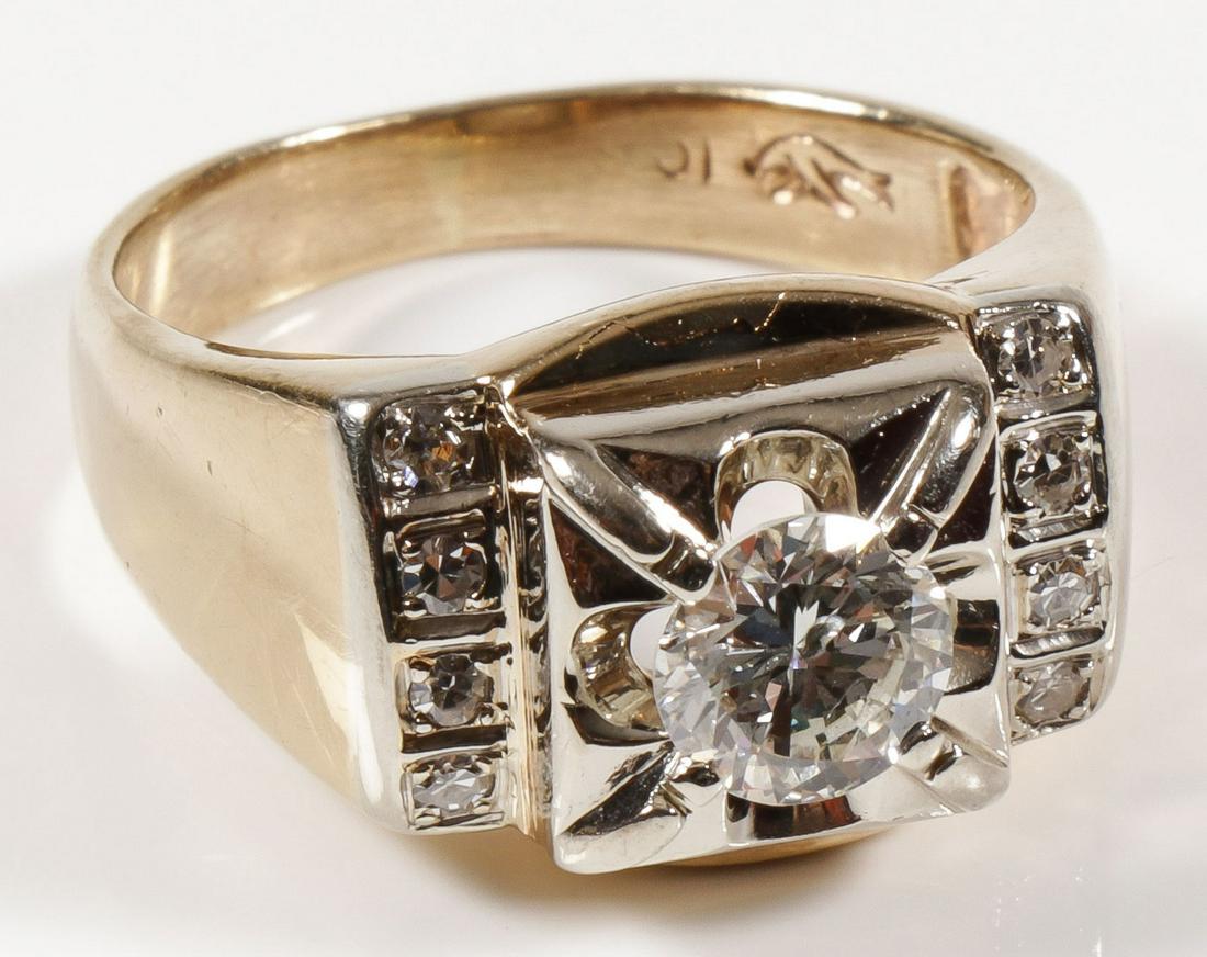 MEN'S BRILLIANT CUT DIAMOND RING: MEN'S BRILLIANT CUT DIAMOND RING. Containing an approximately 1.00 carat round brilliant cut diamond of approximate I1 clarity and G color, measuring 6.5 mm. Flanked on either side by a row of four ap