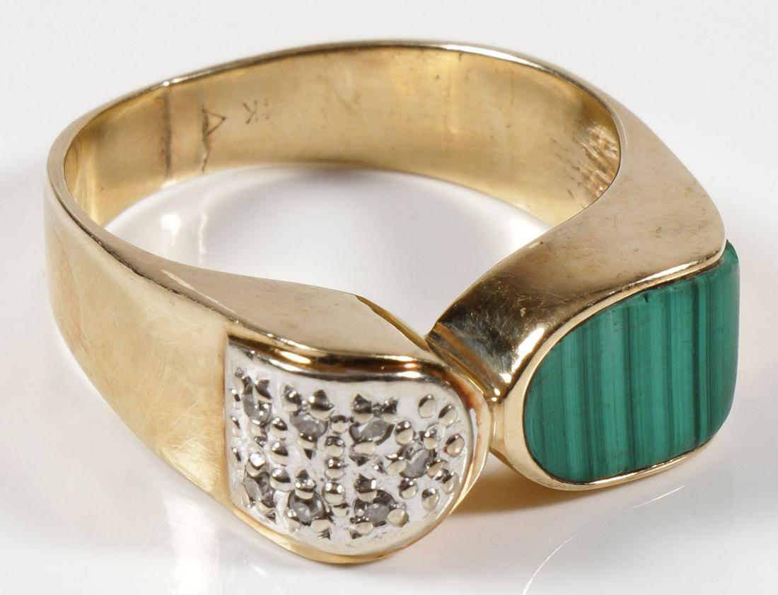 MEN'S GOLD, DIAMOND, & MALACHITE RING: MEN'S GOLD, DIAMOND, & MALACHITE RING. Containing one custom fitted malachite (approximately 11.5 mm x 7.5 mm) offset by a field of seven round single cut diamonds on a field of white gold, approxima
