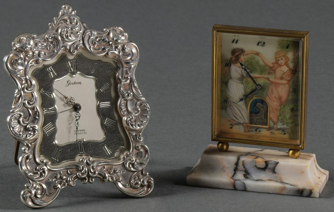 A PAIR OF DESK CLOCKS: A PAIR OF DESK CLOCKS. Comprising a Swiss animated and painted desk clock, the face painted with children playing, and below cupid at his forge, verso inscribed with title I Caught Him and Fab. Suisse