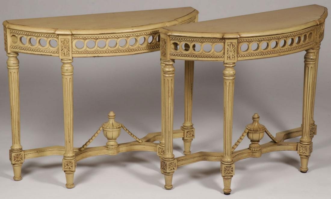 A PAIR OF CARVED WOOD CONSOLE TABLES: A PAIR OF CARVED WOOD CONSOLE TABLES. Comprising two half-moon shaped tables with pierced carved aprons atop four fluted column form legs ending in tapered feet. 39 inches x 32 inches x 13 inches. SHI