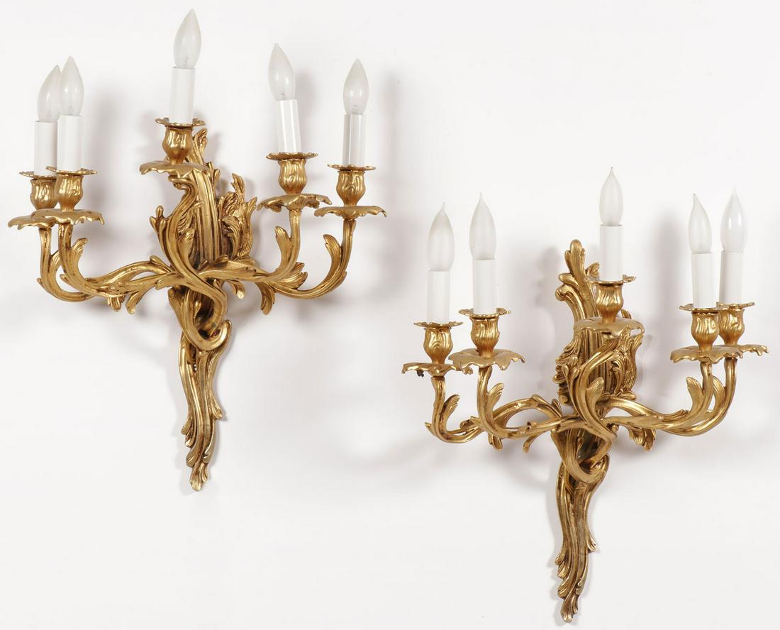 A PAIR OF GILT METAL WALL SCONCES: A PAIR OF GILT METAL WALL SCONCES. Comprising a pair of matching five-light gilt metal wall sconces in the Rococo taste, electrified. The wall mount 18 inches (46 cm). SHIPPING NOTICE: J