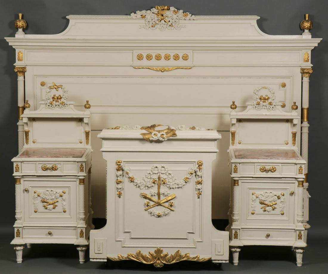 A FRENCH PAINTED BEDROOM SUITE: A FRENCH PAINTED BEDROOM SUITE. Comprising a carved headboard, footboard, and nightstands, each piece carved, painted, and with gilt highlights. The nightstands with rouge marble inlay. The headboard 