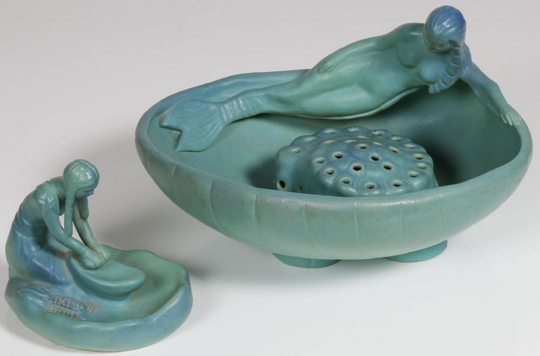 A PAIR OF VAN BRIGGLE ART POTTERY PIECES: A PAIR OF VAN BRIGGLE ART POTTERY PIECES. Comprising a large Mermaid bowl with shell-form flower frog in shaded turquoise, width 14.25 inches. Together with an Indian Maiden grinding corn, width 6.75 
