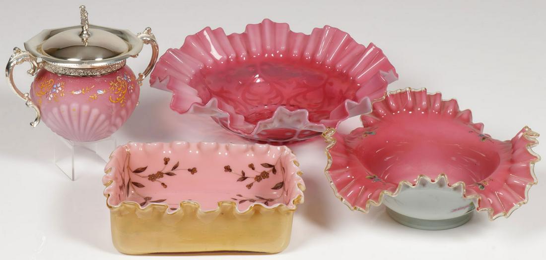 VICTORIAN ART GLASS GROUP: VICTORIAN ART GLASS GROUP. Comprising four individual pieces including a Peachblow shell decorated sugar bowl with silver plated mounts, two bride's baskets, one in cranberry with ruffled rim, the oth