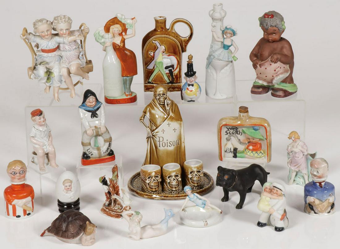 VICTORIAN NOVELTY PORCELAIN: VICTORIAN NOVELTY PORCELAIN. Comprising a good group of sixteen pieces of porcelain including bisque, champagne, dance hall bottles, a sailor life preserver bottle, a naughty "spanking" bottle, a baby