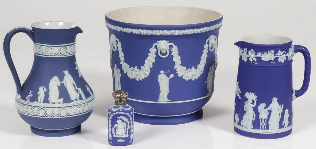 WEDGEWOOD PORCELAIN GROUPING: WEDGEWOOD PORCELAIN GROUPING. Comprising four blue and white Wedgewood pieces including a jardinière, a wine carafe and pitcher, as well as a scent bottle with hinged metal cap, greatest height 7.25 