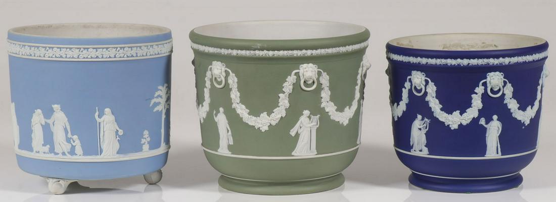 THREE WEDGEWOOD JASPERWARE JARDINIÈRES: THREE WEDGEWOOD JASPERWARE JARDINIÈRES. The sides of each modeled with classical scenes in light blue, dark blue, and olive green, greatest height 8.25 inches, greatest diameter 9.3 inches. SHIPPING 
