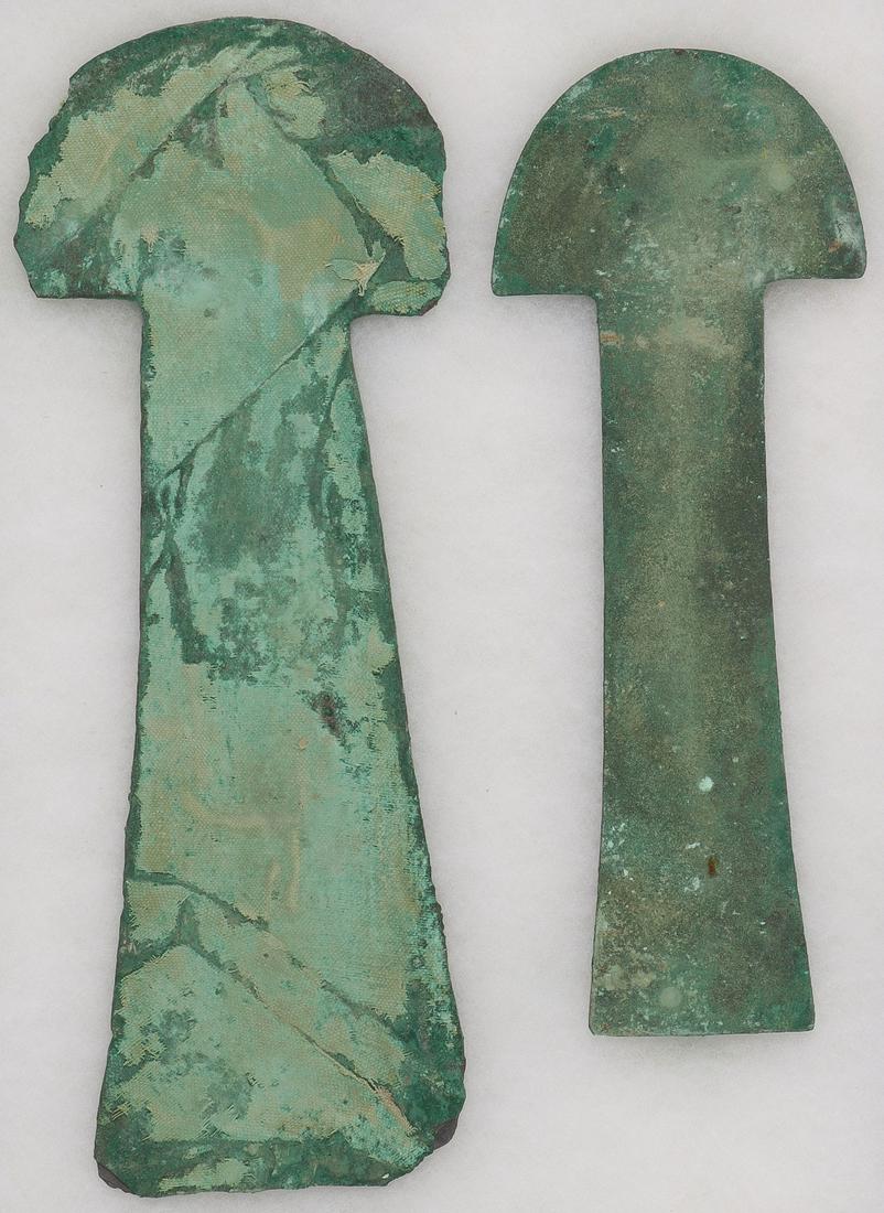 PAIR OF PRE-COLUMBIAN BRONZE TUMI: PAIR OF PRE-COLUMBIAN BRONZE TUMI. Of traditional form with verdigris patina and one with textile remnant embedded in surface. Greatest length 13.25 inches (34 cm). SHIPPING NOTICE: Jackson's is