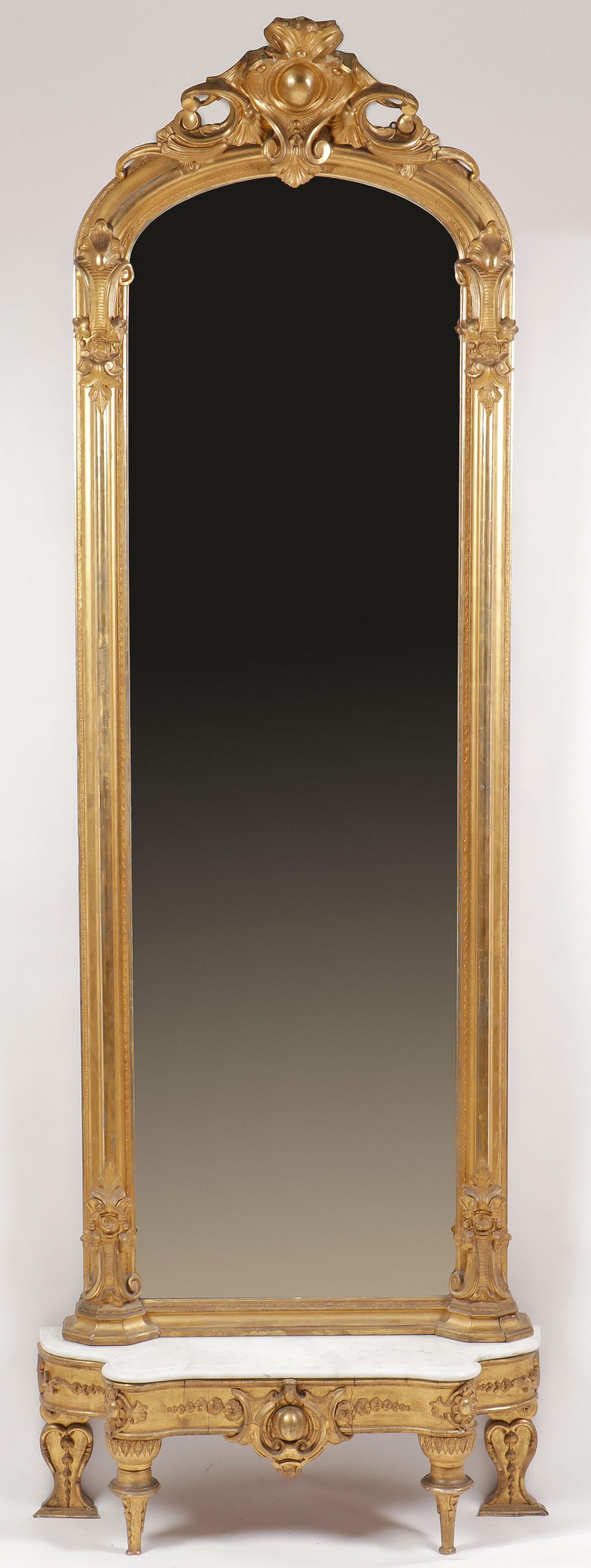 LARGE GILT PIER MIRROR WITH CONSOLE TABLE: LARGE GILT PIER MIRROR WITH CONSOLE TABLE. The ornate canopy with fanned acanthus above a foliate carved frame encompassing an arched mirrored plate, height 95 inches, width 32.2 inches, depth 4 inche