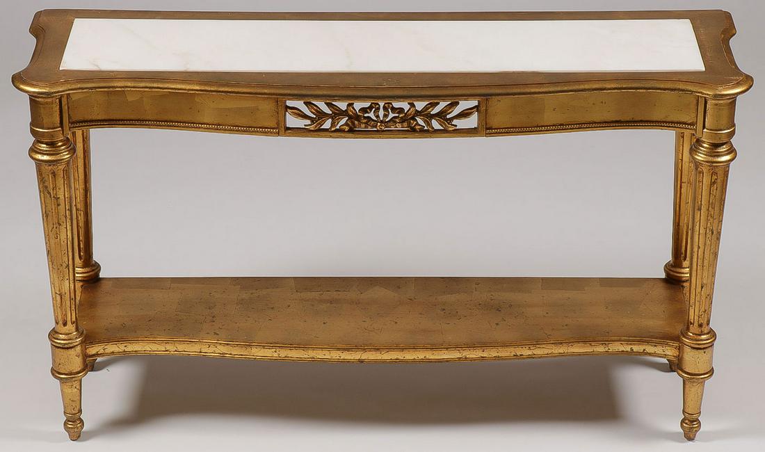 A GILT WOOD CONSOLE TABLE: A GILT WOOD CONSOLE TABLE. Having inset white marble top over conforming beaded frieze raised on four tapering fluted legs terminating in toupee feet and joining a serpentine undertier, height 29.25 i