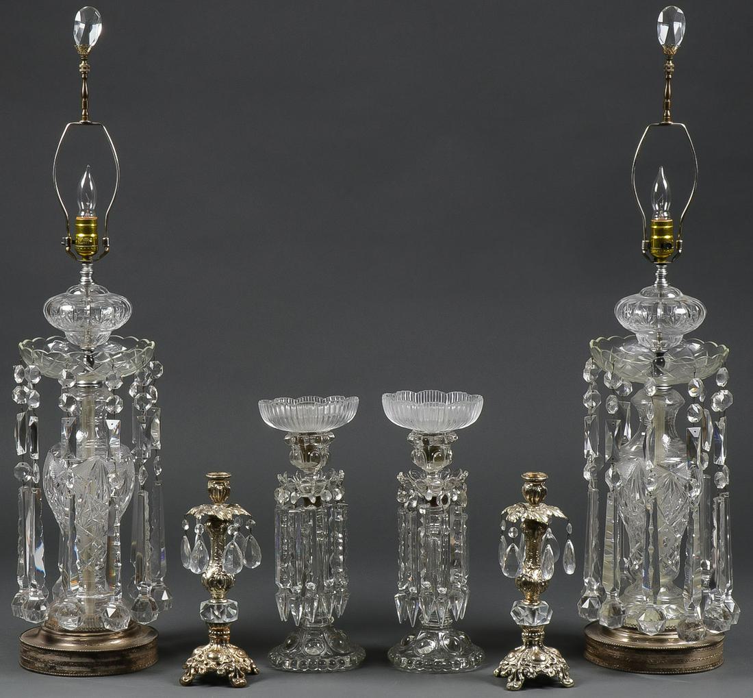 CRYSTAL LIGHTING GROUP: CRYSTAL LIGHTING GROUP. Comprising two large and impressive electrified luster form table lamps with cut glass bodies and suspended prisms set in metal bases. Together with two mantel lusters candlest