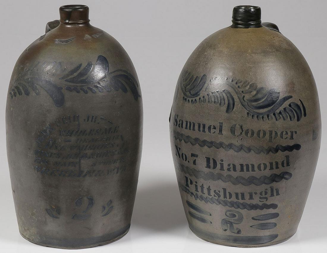 PR GREAT STONEWARE JUGS, W VIRGINIA & PITTSBURGH: PR GREAT STONEWARE JUGS, W VIRGINIA & PITTSBURGH. Comprising a two-gallon John Reid Jr. jug with cobalt foliate motif on shoulder above stenciled advertising "Wholesale Dealer in Rye Whiskeys, Wines, 