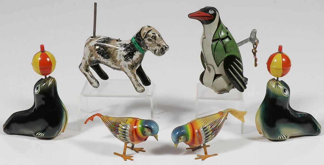 SIX TIN WIND-UPS AND FRICTION TOYS: SIX TIN WIND-UPS AND FRICTION TOYS. Comprising two Lehmann "Western Germany" friction seals, a pair of German key wind pecking birds, a key wind French Joustra Gigi penguin, and a key wind tailspin O