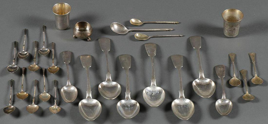 A MOSTLY RUSSIAN SILVER LOT: A MOSTLY RUSSIAN SILVER LOT. Comprising 14 individual Imperial Russian period silver utensils including a footed salt, two shot glasses, serving spoons, coffee spoons, and demitasse spoons, as well as
