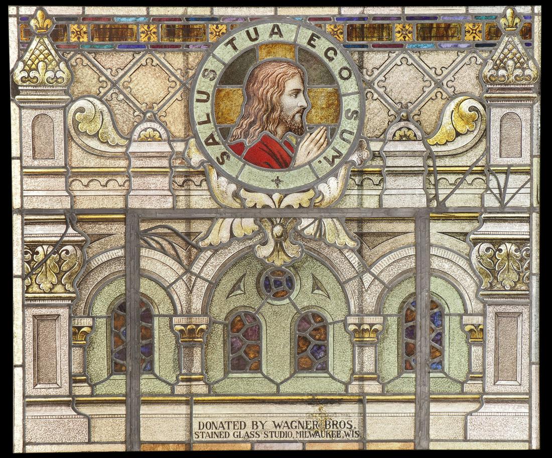 STAINED AND LEADED GLASS WINDOW OF CHRIST C 1920: AN INTERESTING STAINED AND LEADED GLASS WINDOW OF CHRIST, CIRCA 1920. Within an ornate, architectural element of arches and spires, a roundel of Christ with hands folded in prayer, and encircled with