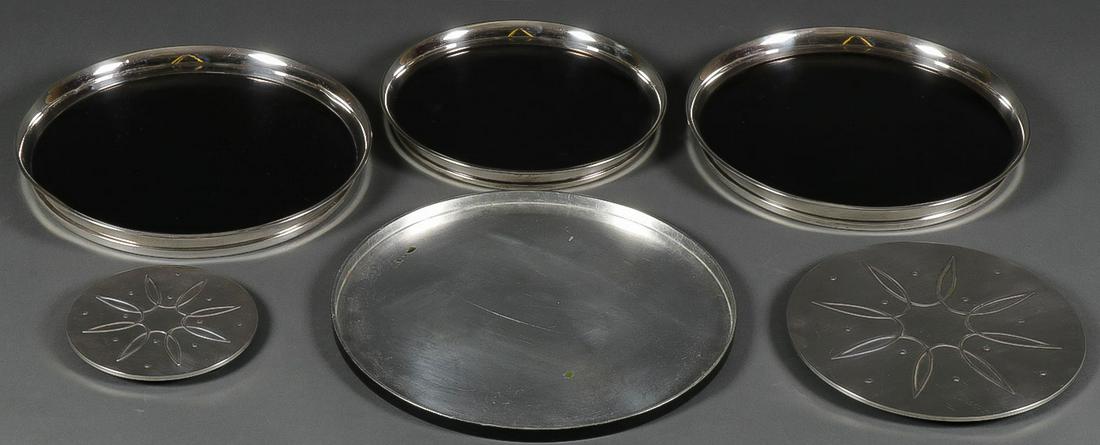 SILVER TRAYS AND TRIVETS: SILVER TRAYS AND TRIVETS. Comprising two Towle silver covered composition trivets, three Gorham silver mounted trays, and a non-metal circular tray, greatest measurement 14 inches.SHIPPING NOTICE: J