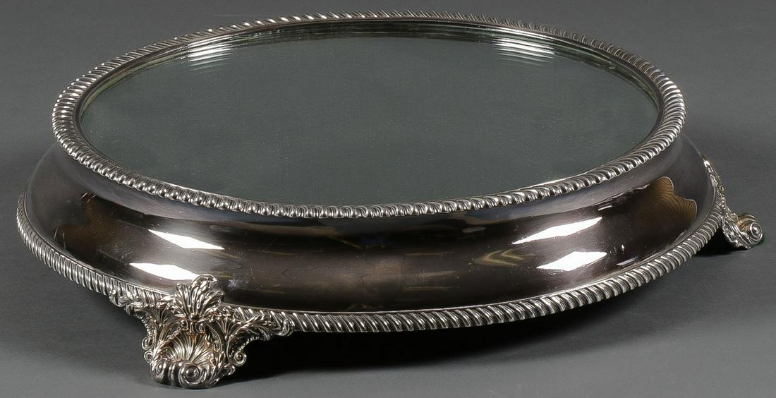 AN IMPRESSIVE MIRRORED PLATEAU: AN IMPRESSIVE MIRRORED PLATEAU. A large and impressive likely Sheffield plate footed mirrored plateau with mahogany frame and rope twist borders, indistinguishable marks. Diameter 17.25 inches. SHIPPI