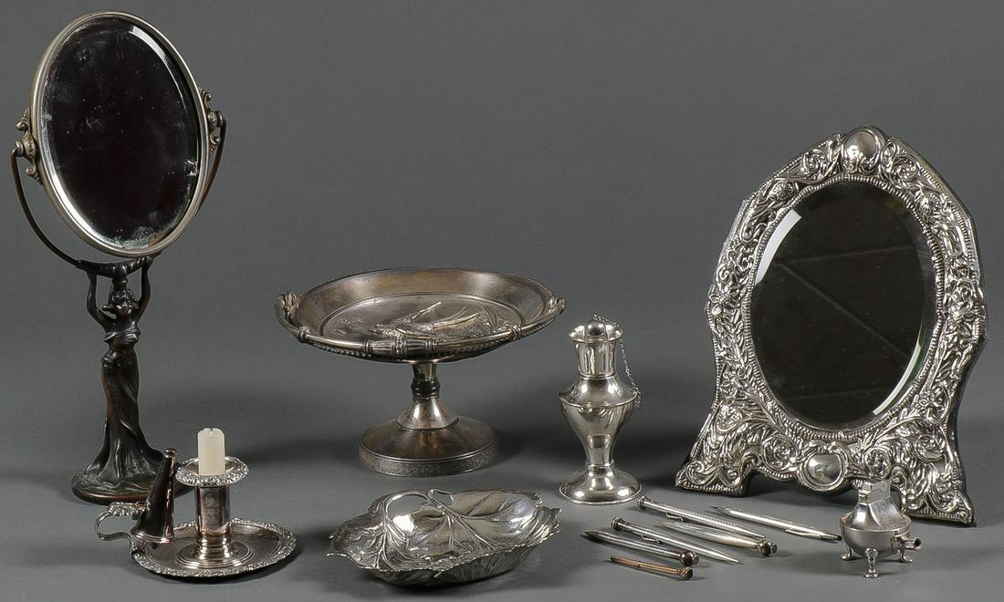 A STERLING AND SILVER PLATE GROUP: A STERLING AND SILVER PLATE GROUP. Comprising a sterling leaf-form tray, a sterling table lighter, five sterling pens, as well as a silver-plated chamber stick, a silver-plated mirror with strut stand