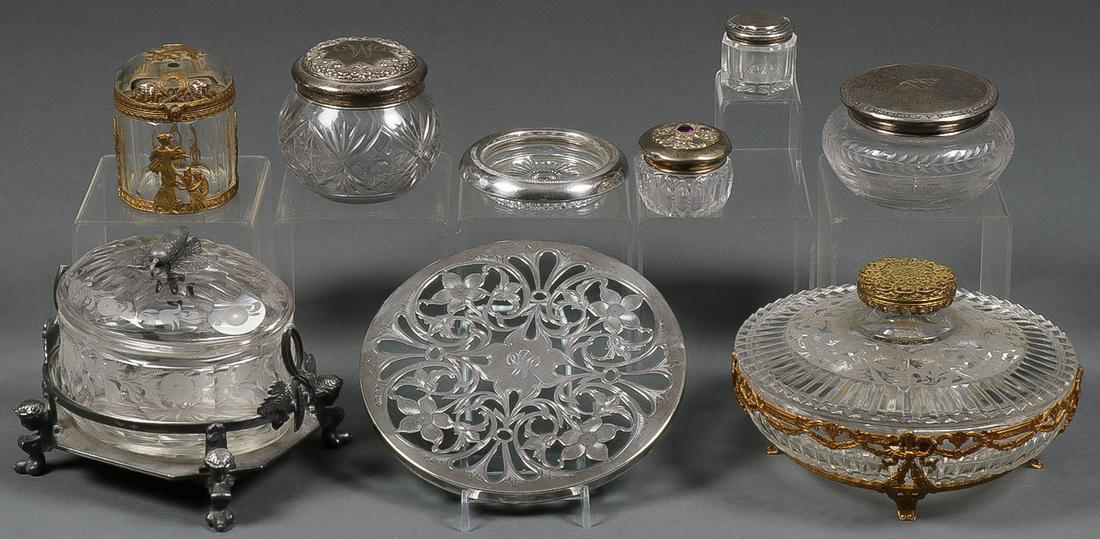 SILVER & METAL MOUNTED GLASS: SILVER & METAL MOUNTED GLASS. Comprising an assortment of six dresser boxes, four with sterling lids, two monogrammed, and a round trivet with floral sterling overlay and sterling rimmed star-cut coas