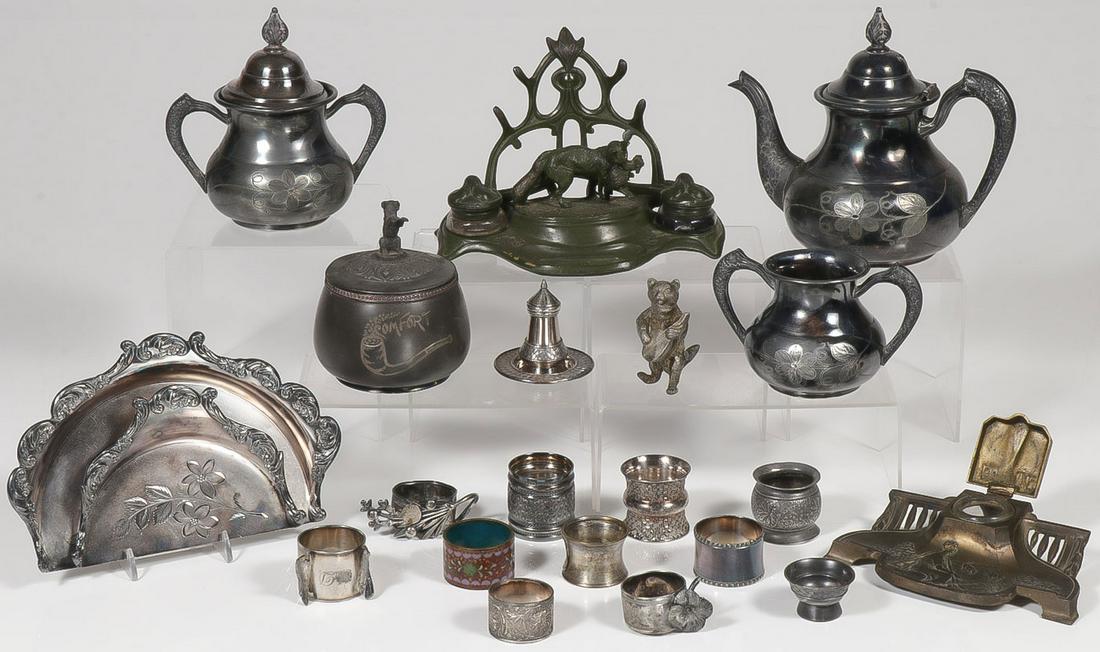 VICTORIAN SILVER PLATE & MORE: VICTORIAN SILVER PLATE & MORE. Comprising over 20 silver plated and other metal articles including 10 napkin rings, a kitten playing a stringed instrument, a tobacco jar with puppy finial, a matching 