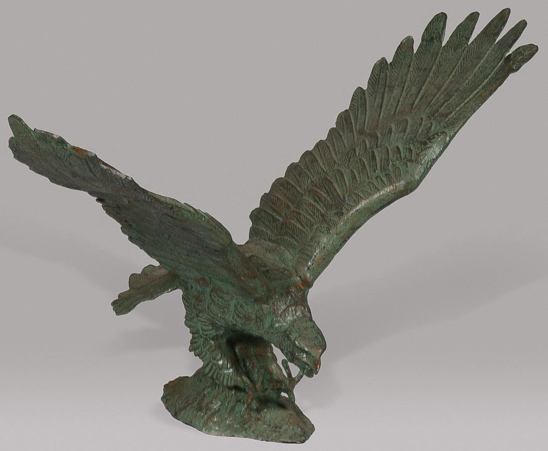 LARGE BRONZE EAGLE GARDEN SCULPTURE: LARGE BRONZE EAGLE GARDEN SCULPTURE. Comprising a large and impressive sculpted bronze figure of a bald eagle as it prepares to grab its prey. Of good anatomy and proportions and overall with verdigri
