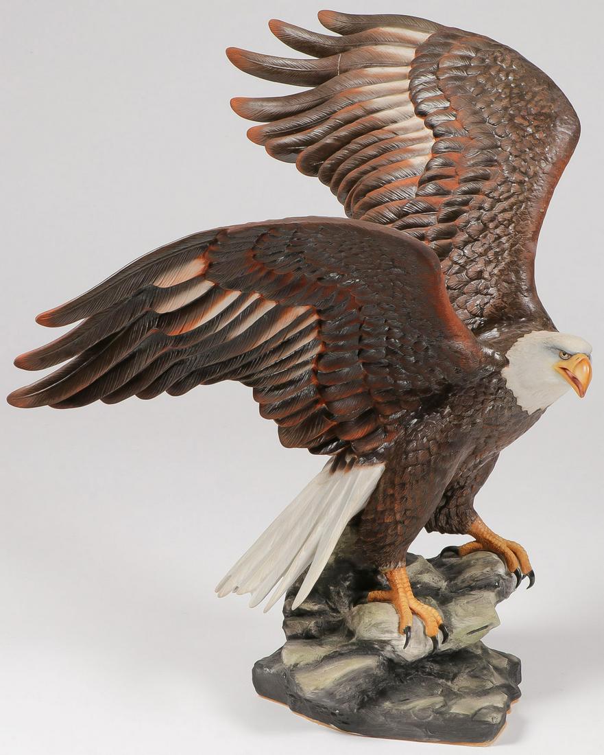 IMPRESSIVE PORCELAIN EAGLE: LARGE RUYCKEVELT PORCELAIN EAGLE. Comprising a large and impressive hand-painted bald eagle on rocky outcrop. Of good proportions and exquisite detail, the underside of base marked "The Majestic Ameri