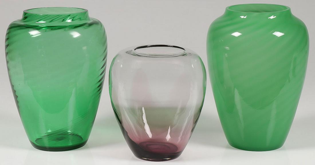 THREE STEUBEN VASES: THREE STEUBEN VASES. Comprising a green swirl vase, a jade vase, and a purple to clear vase. No visible marks. Greatest height 11 inches. SHIPPING NOTICE: Jackson's is your sole and only source