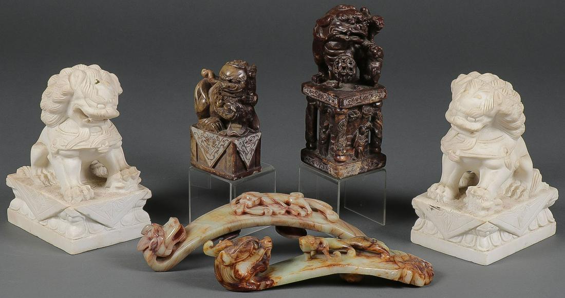 AN INTERSTING CHINESE CARVED STONE GROUPING: AN INTERESTING CHINESE CARVED STONE GROUPING. Comprising a pair of matching white carved stone foo dogs, a large carved stone stamp depicting various scenes including immortals and foo dogs, a carved 