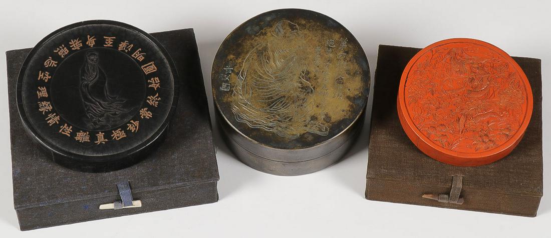 CHINESE INK CAKES: CHINESE INK CAKES. Comprising two boxed ink cakes, one black, one red, and an ink container with engraved covered lid depicting a Buddhist monk. Greatest diameter 4.75 inches. SHIPPING NOTICE: Jack